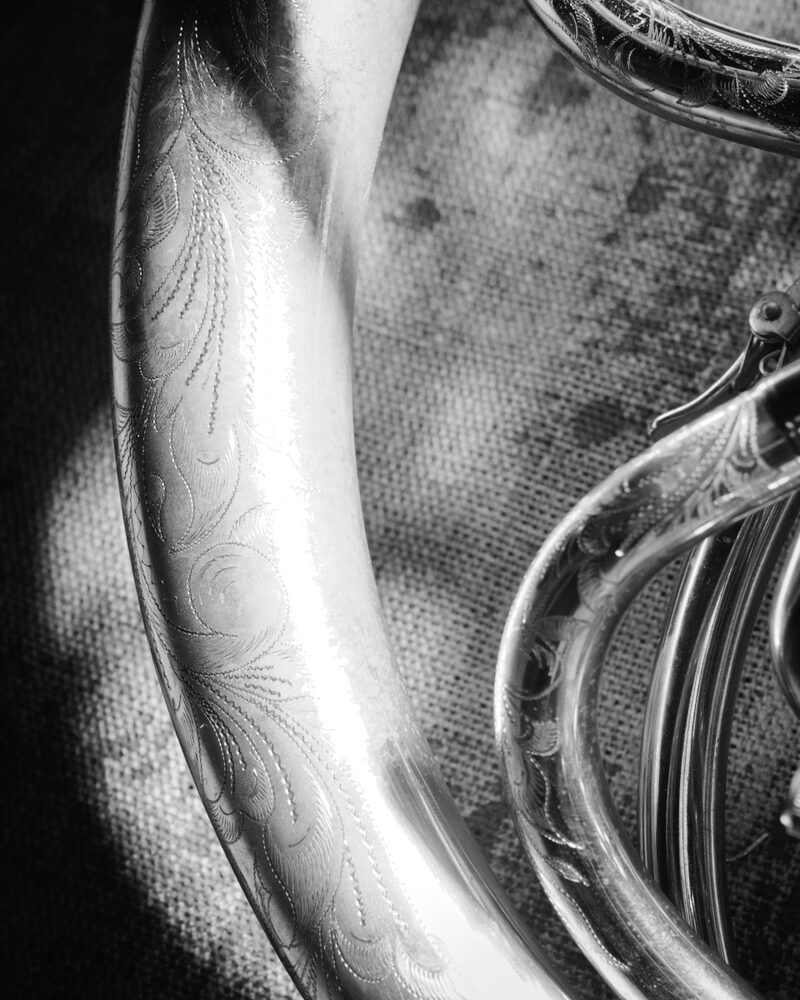 Curve of engraved tubing catching the light